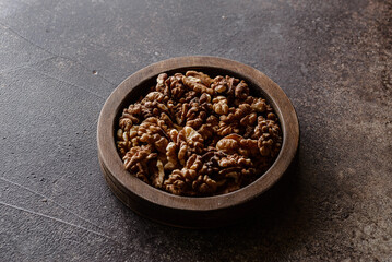 organic raw walnuts in a wooden bowl