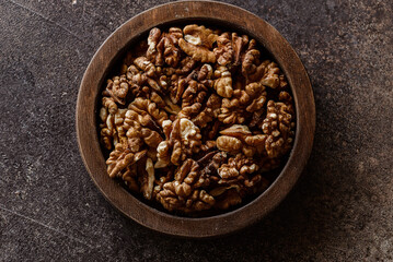 organic raw walnuts in a wooden bowl