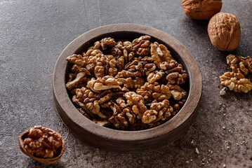organic raw walnuts in a wooden bowl