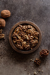 organic raw walnuts in a wooden bowl