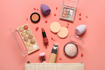 Stylish cosmetic bag with makeup products on coral background
