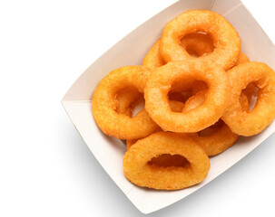 Paper box with fried breaded onion rings on white background