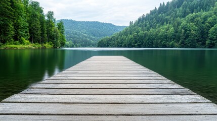Naklejka premium Calm and Serene Wooden Dock Extending into Tranquil Lake Surrounded by Lush Green Forested Mountains