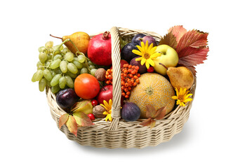 Wicker basket with different fresh fruits and flowers on white background
