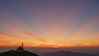 Obraz premium Silhouette of a mosque at dawn against a pastel sky, capturing the essence of tranquility