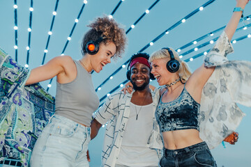 Friends listening music and dancing at silent disco party