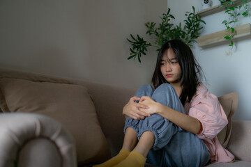 Fototapeta premium Asian depression teenager covering her face feeling anxious and unhappy.