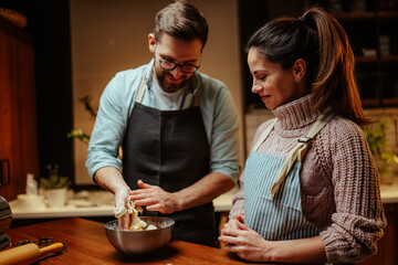 Couple enjoying baking together in cozy kitchen