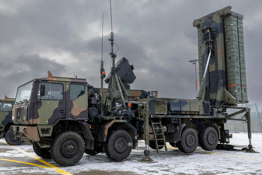A SAMP T air defense system with Aster 30 missiles deployed on a military truck in a snowy environment under a cloudy sky.