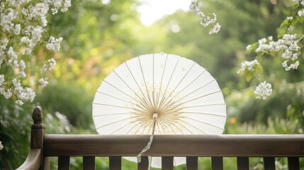 A white parasol rests gently on a wooden bench outdoors