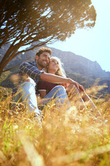Relax, hug and love with couple in nature for bonding, park conservation date and mountain view. Happiness, holiday and peace with man and woman in grass field for vacation, commitment and trust