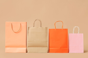 Different shopping bags on brown background