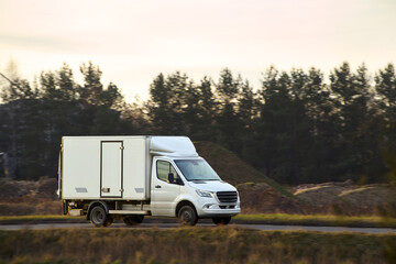 Delivery vehicle passing countryside area
