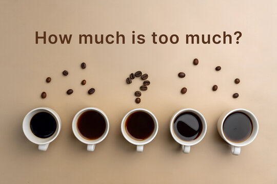 Row of Coffee Cups With Question About Caffeine Consumption on a Flat Surface