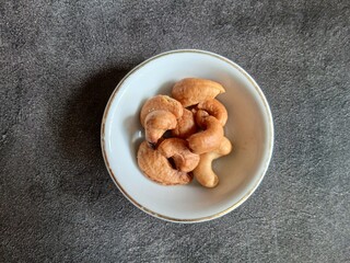 Bowl of Roasted Cashew Nuts on dark background