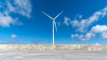 Coastal wind turbine generates clean energy under a blue sky