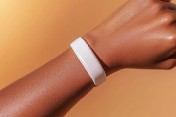 Close-up of african adult female wrist with white wristband. Silicone bracelet, paper wristband mockup