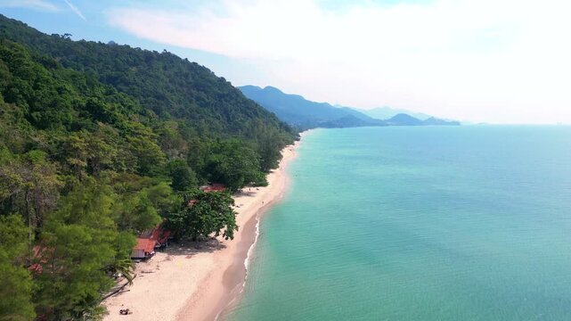koh chang Island, thailand showing a beautiful tropical white sand beach and lush rainforest meeting turquoise water. Fabulous aerial view flight descending drone