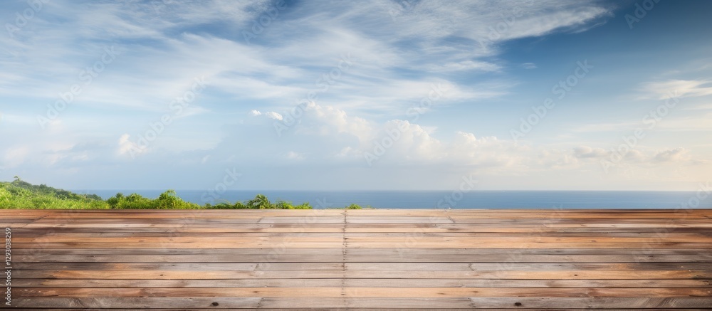 Poster wooden planked surface in foreground with a serene coastal view and blue sky in the background ideal