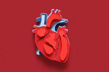 Paper heart on red background