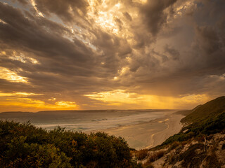 Dramatic sunset seascape with approaching thunderstorm clouds 