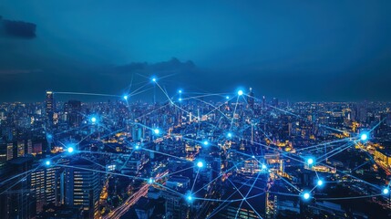 Fototapeta premium Aerial view of a modern city at night, interconnected by a network of glowing lines and points.