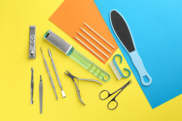 Set of pedicure tools on color background, flat lay