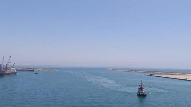 Moroco agadir apr 24 2024 Cargo Ship and Tugboat in a Busy Industrial Port