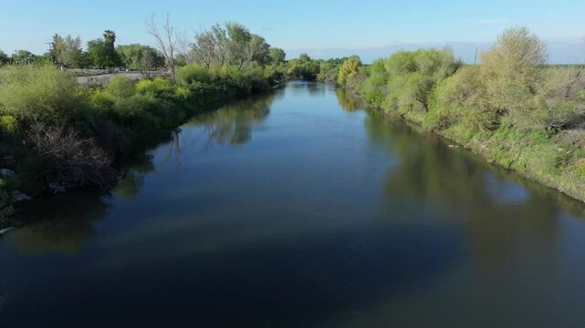 Moving low over San Joaquin River irrigation canal