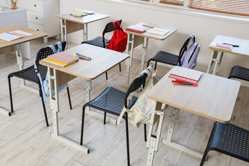 Interior of empty classroom with school desks