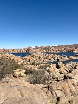 Rocky desert landscape with Watson Lake and distant mountains