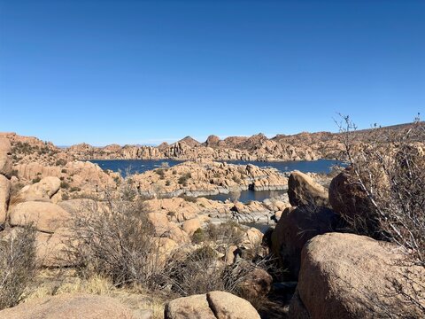 Scenic view of Watson Lake with rugged rock formations, desert plants