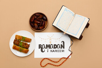 Greeting card, dates, Koran and baklava on beige background. Ramadan celebration