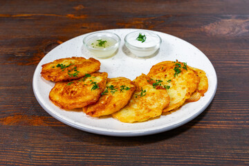 Delicious potato pancakes served with creamy dipping sauce
