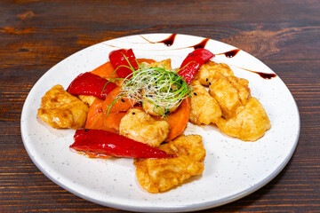 Flavorful dish with chicken and colorful vegetables on a plate