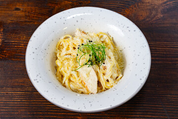 Delicious creamy pasta served in a stylish restaurant bowl