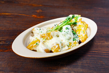Delicious cheese-covered broccoli with baked potatoes served hot