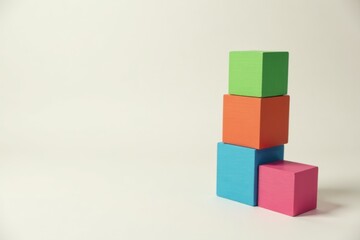 Naklejka premium Colorful blocks forming an incomplete structure on a white background, symbolizing growth, development, and the potential for expansion.