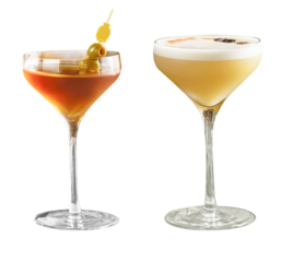 Two stylish cocktails served in elegant martini glasses. One features a classic Bloody Mary with olives, while the other is a creamy espresso cocktail with frothy foam.