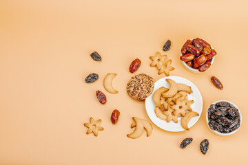 Traditional Ramadan Kareem concept snack for Iftar or Suhoor meal on light orange background