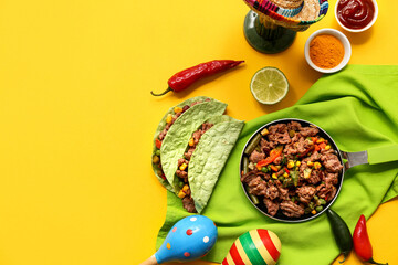 Frying pan with traditional Mexican food and maracas on yellow background. Cinco de Mayo (Fifth of May) celebration
