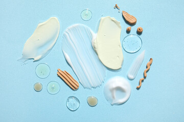 Composition with different samples of cosmetic products on color background