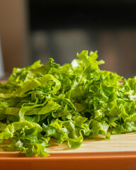  fresh sliced chopped lettuce on a wooden cutting board close-up