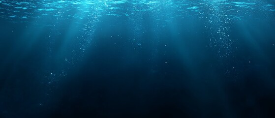 Obraz premium The image is of a deep blue ocean with a lot of bubbles