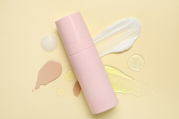 Bottle of cosmetic product and samples on color background