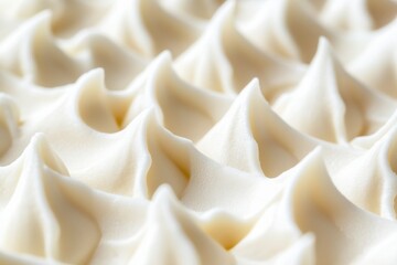 Close-up of beautifully piped cream peaks on a dessert highlighting skillful pastry craftsmanship and texture