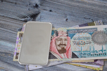 Saudi Arabian money banknotes of riyals and Silver precious metal 250 GM bar of pure silver, The...