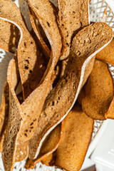 Rye bread is cut into thin slices. Background with the texture of sliced rye bread.