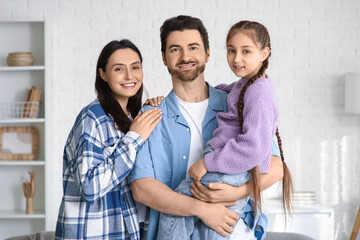 Happy couple with adopted girl at home