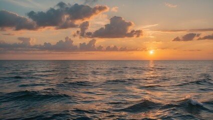 Serene sunrise over calm ocean with golden hues reflecting on water and gentle waves creating a tranquil seaside atmosphere.